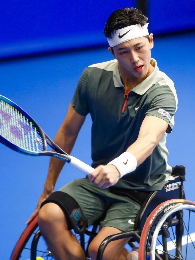Wheelchair tennis player Tokito Oda plays a backhand