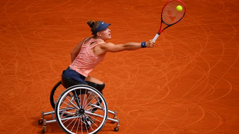 A female wheelchair tennis athlete in action at the French Open
