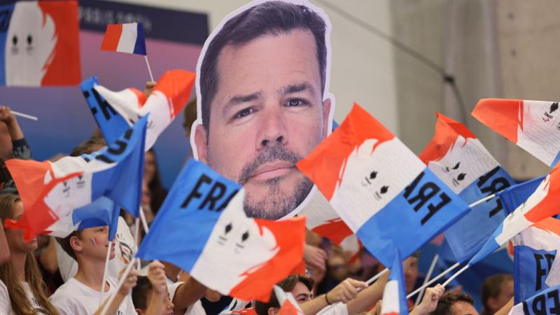 A group of French fans with flags in the stands