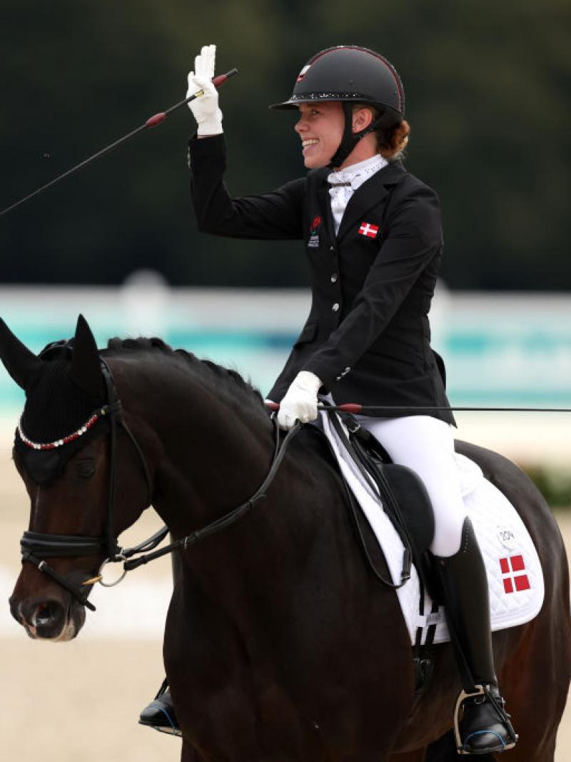 Para equestrian rider Katrine Kristensen smiles and waves on her horse