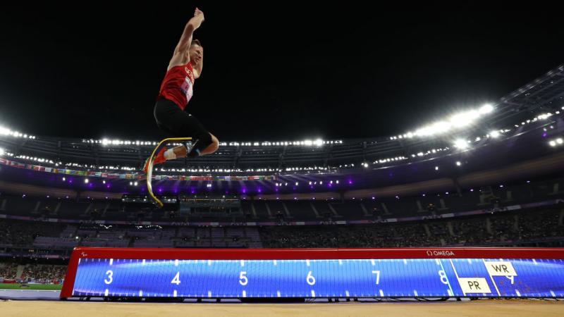 A man with a prosthetic leg competing in the long jump at Stade de France