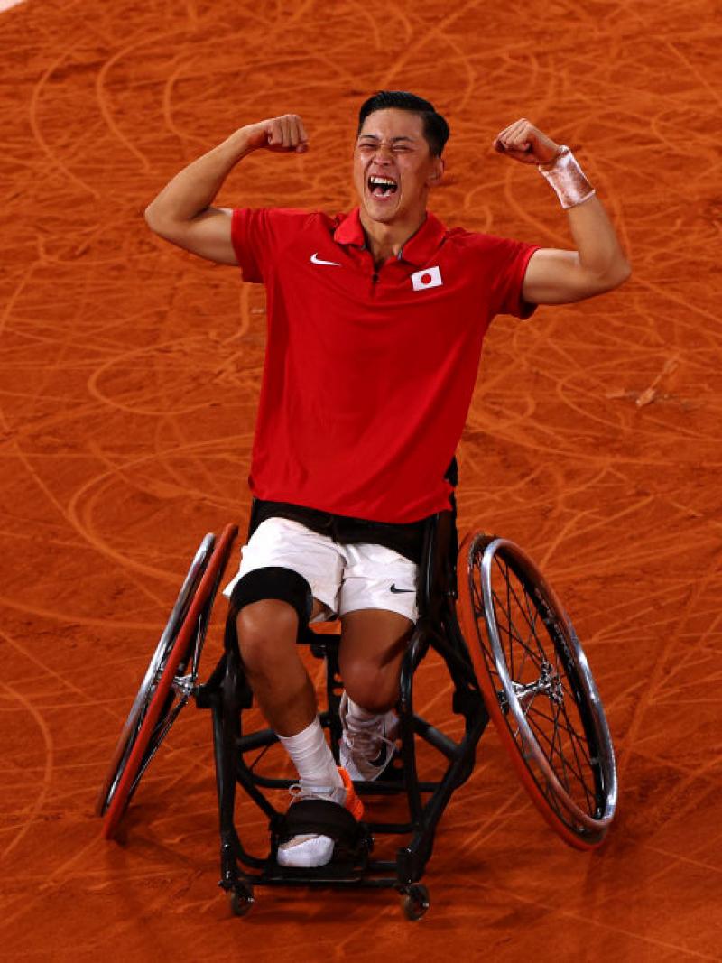 Wheelchair tennis player Tokito Oda screams with joy on a clay court