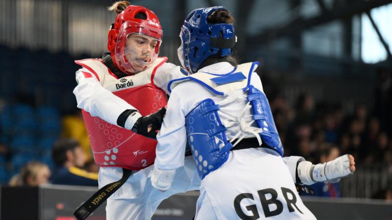 Two female Para taekwondo athletes in action