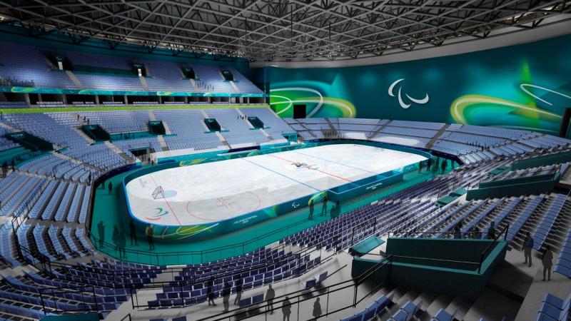 An image of a Para ice hockey rink. There are blue and green banners and signs