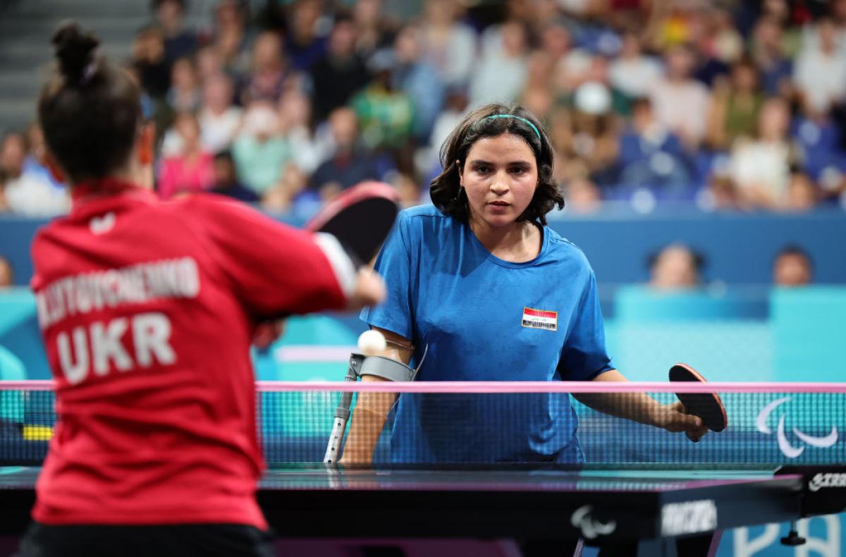 A female Para table tennis player returns a shot