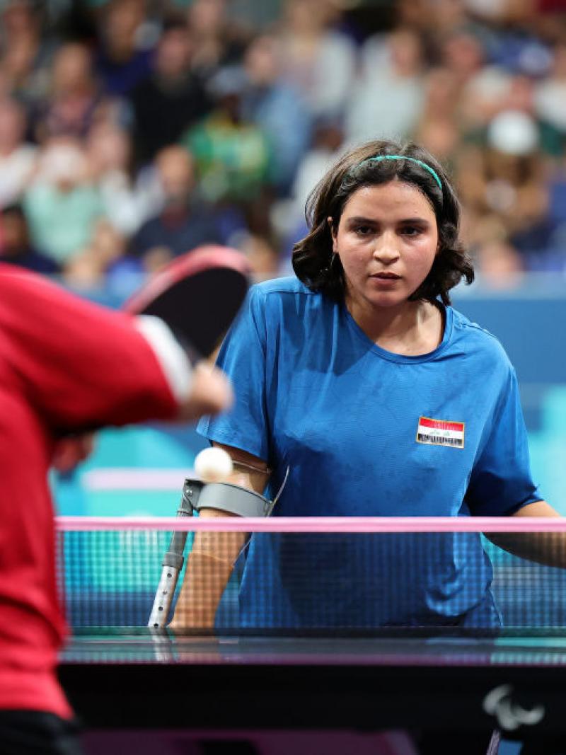 A female Para table tennis player returns a shot