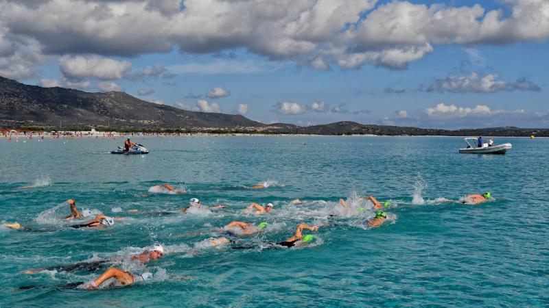 A group of swimmers in an open water event in Sardinia
